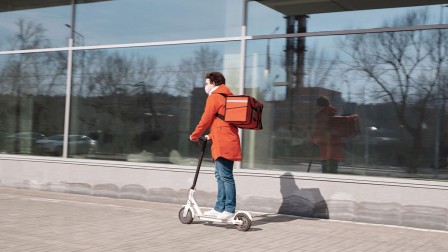 Delivery service Man delivering food on an e-scooter