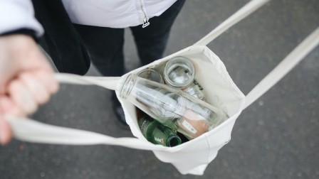 Sustainable packaging solutions Woman holding a bag full of glass