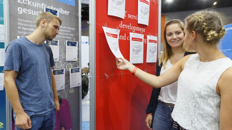 gamescom visitors in front of a notice board with job offers