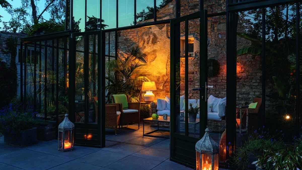 Eine beheizbare, gläserne Orangerie fügt sich harmonisch an die rustikale Ruine an und lädt stimmungsvoll beleuchtet auch während der Abendstunden zum Verweilen ein – Foto: Gölz/Neubauer, Gärten des Jahres 2019, Callwey Eine beheizbare, gläserne Orangerie fügt sich harmonisch an die rustikale Ruine an und lädt stimmungsvoll beleuchtet auch während der Abendstunden zum Verweilen ein – Foto: Gölz/Neubauer, Gärten des Jahres 2019, Callwey